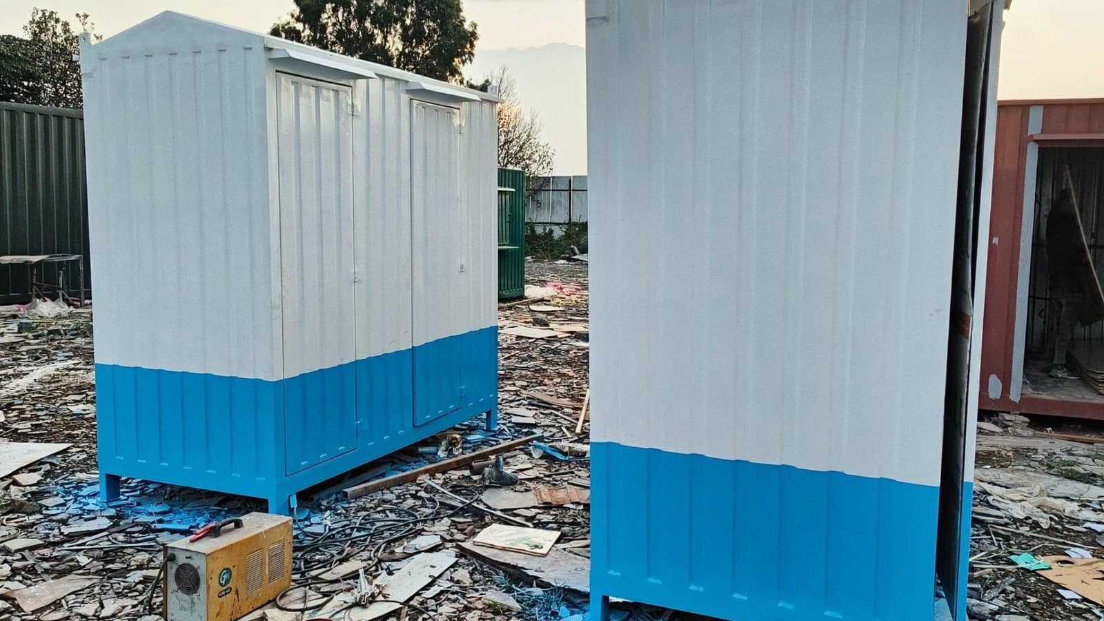 wo white and blue portable cabins on a construction site